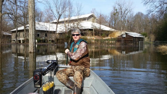 Eric Maynard navigating flood waters at the Delta Rivers Nature Center. Credit: Brett Crow