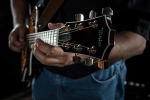 Zoomed in photo of Dave Sadler’s guitar while held by Sadler. Credit: John David Pittman