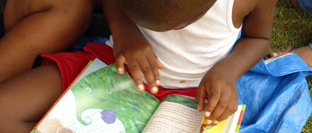Child Reading Book. 23A303CC-B12E-4F20-B23C-D3669DF8D108
