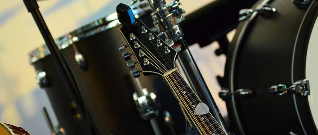 Drum set with partial guitars showing. Image for live music, local bands, jam sessions.
