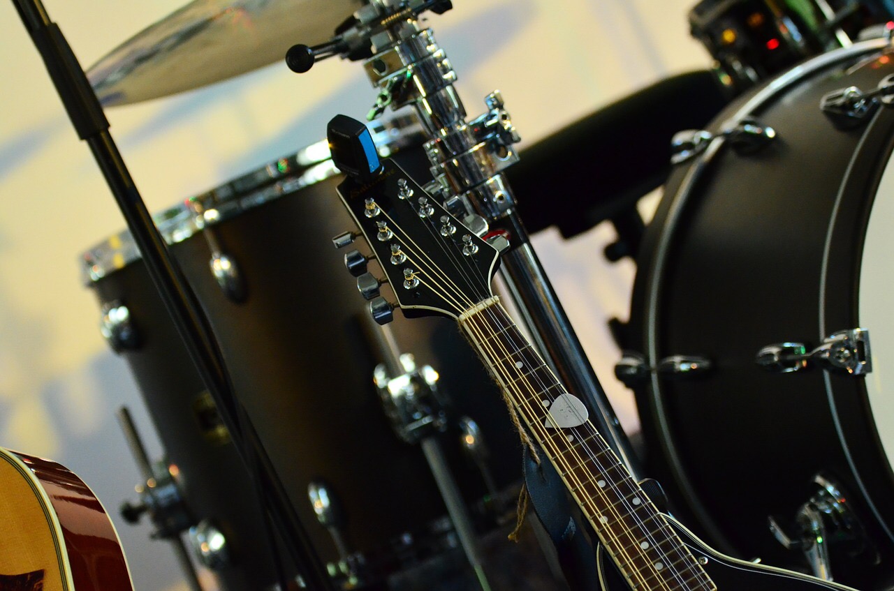 Drum set with partial guitars showing. Image for live music, local bands, jam sessions.